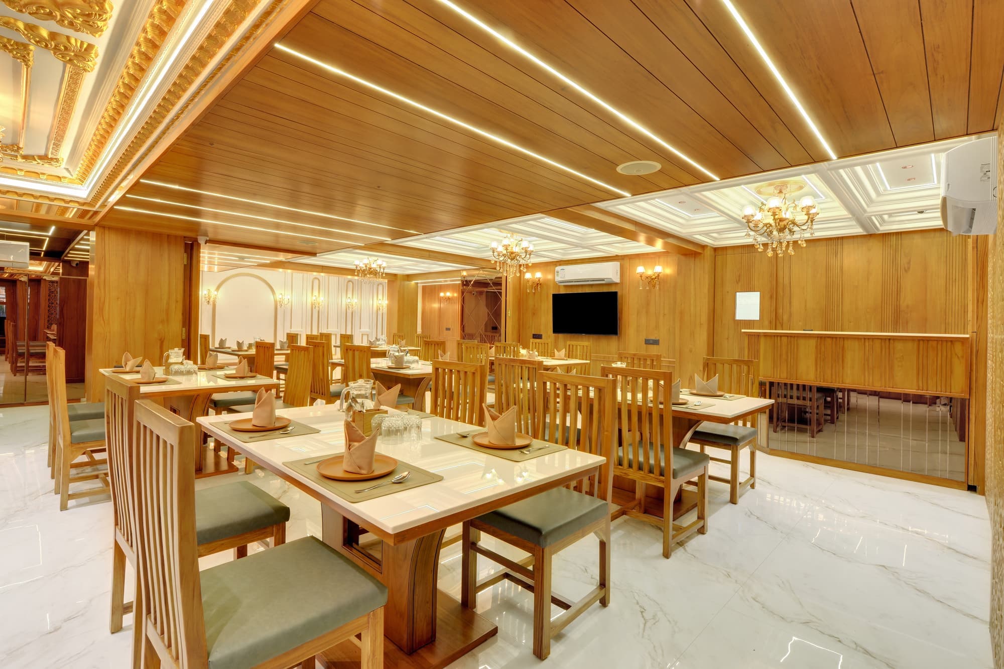 Hotel Shital Inn restaurant dining area with tables in Vastrapur Ahmedabad